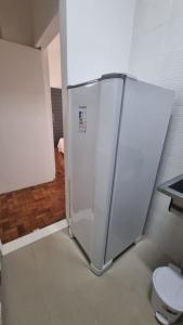 a white refrigerator in a room with a toilet at Apê in Copacabana in Rio de Janeiro