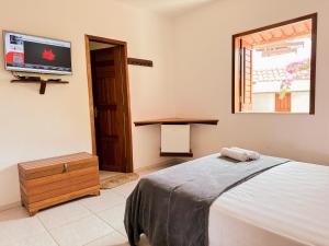 En eller flere senger på et rom på Pousada Morada do Sol