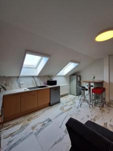 a kitchen with marble floors and skylights at Haus Grimming in Öblarn
