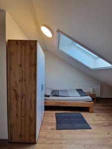 an attic bedroom with a bed and a window at Haus Grimming in Öblarn