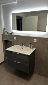 a bathroom with a sink and a mirror at L&L in Korb