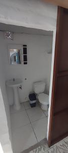 a small bathroom with a toilet and a sink at Casa travesia in Ayampe