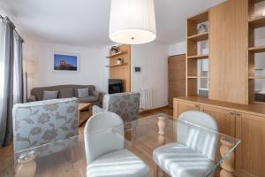 a living room with a glass table and chairs at Chalet Falorie in Cortina dʼAmpezzo