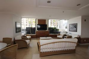 a living room with couches and chairs and a television at Ozped Private Flats Manhatan in Brasília