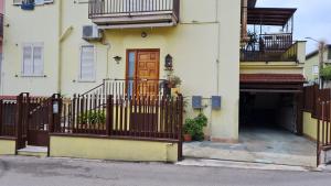a white building with a gate and a door at Casa Arianna in Avella