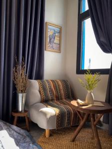 a living room with a couch and a window at Homestay Sài Gòn in Phu Quoc