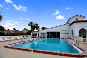 a large swimming pool in front of a building at 2 Bed/2 Bath Beach Condo in St. Augustine