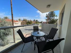 a balcony with a table and chairs and a view of a street at Majestic Boutique Apartment/2BR in Nicosia