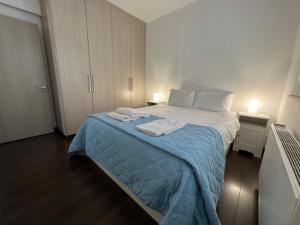 a bedroom with a bed with towels on it at Majestic Boutique Apartment/2BR in Nicosia