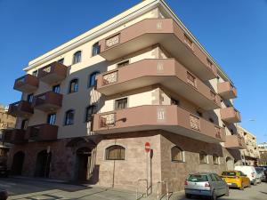 a tall building with balconies on the side of it at Hotel Traiano in Civitavecchia