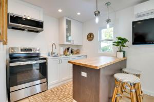 a kitchen with white cabinets and a counter top at Napa Studio with Shared Hot Tub Close to Wineries! in Napa
