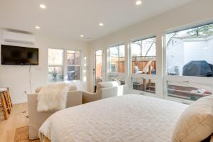 a white bedroom with a large bed and windows at Napa Studio with Shared Hot Tub Close to Wineries! in Napa