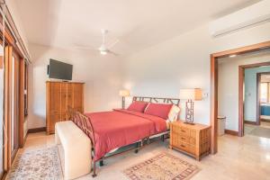 a bedroom with a bed and a television in it at 3BR Beachfront townhouse at Puerto Bahia in Santa Bárbara de Samaná +20 photos