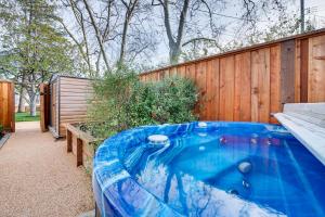 a hot tub in a backyard with a wooden fence at Central Napa Vacation Rental - Walk Downtown! in Napa