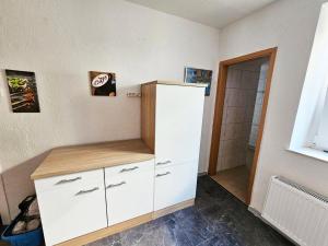 a white cabinet in a room with a shower at Ferienwohnung in zentraler Lage in Frechen