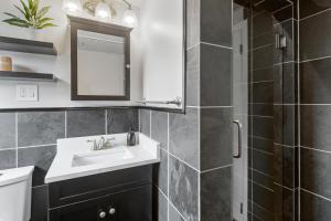 a bathroom with a sink and a shower at 3-min Walk To Beach! Private Luxury Backyard! in Dennis +26 photos
