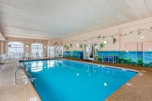 a swimming pool with blue water in a building at Quality Inn Ocean City Beachfront in Ocean City