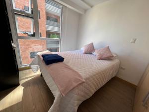 a bedroom with a bed and a large window at Cityhaus apartment zone 10 near hotel area in Guatemala