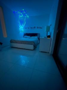 a bedroom with a bed with a blue light at SAN NICOLA LUXURY in Bari