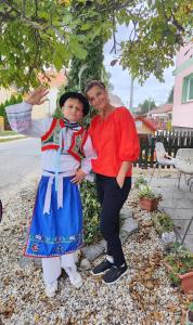 a woman standing next to a little girl in a costume at Apartmán Café u Kordulky in Ratíškovice