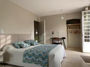 a bedroom with a large bed with blue pillows at EN VILLE à LA CAMPAGNE 2 in Louhans