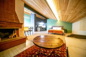 a living room with a table and a fireplace at Chalet Papa Basili in Gudauri