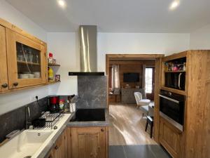 a kitchen with a sink and a stove at CHALET DE CHARME LE GOLEON - 3 Chambres - VALLOIRE CENTRE in Valloire