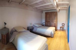 a bedroom with two beds and a table and chairs at FONT DE RAINE in Rottier