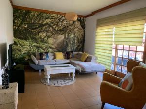 a living room with a couch and a table at Chalet Tegueste Isla de Tenerife in Tegueste