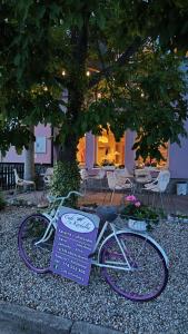 a bike parked on the ground with a sign next to it at Apartmán Café u Kordulky in Ratíškovice