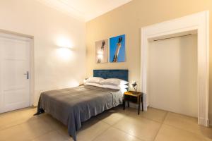 a bedroom with a bed with two pillows on it at Residenza Partanna by Napoliapartments in Naples