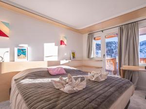 a bedroom with a large bed with towels on it at Appartement chalet familial, 8 personnes, 3 balcons, proche pistes et commerces - FR-1-314-120 in Morzine