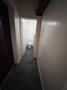 an empty hallway with a toilet in a bathroom at Glo Stay @ Hibbert Crescent in Skegby