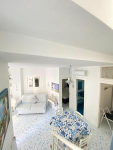 a living room with a white couch and a table at Arime Apartment in Ischia