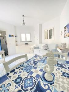 a living room with a blue and white floor at Arime Apartment in Ischia