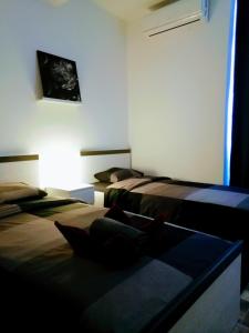 a room with two beds and a window at Pula Center - Studio Apartments in Pula