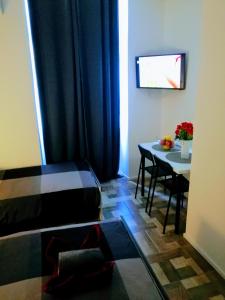 a small living room with a table and a couch at Pula Center - Studio Apartments in Pula
