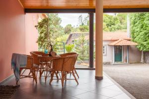 a dining room with a table and chairs on a patio at Quinta do Santo by LovelyStay in Santo da Serra