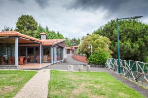 a house with a garden and a street light at Quinta do Santo by LovelyStay in Santo da Serra +19 photos