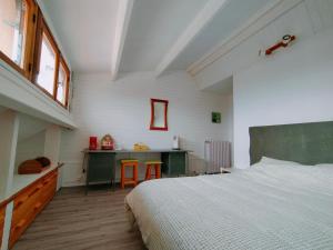a bedroom with a bed and a desk in it at La Pause Vélo gite d'étape in Guéret