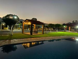 a house with a gazebo and a swimming pool at Hotel Paraiso in Tepic