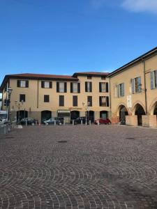 a large building with a brick road in front of it at Attico “the Queen” in Caravaggio