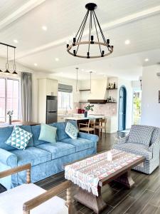 a living room with a blue couch and a table at Seamoni Seaview Villa 02 - Novaworld Phan Thiết in Phan Thiet