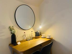 a dressing table with a mirror on a wall at The Punchbowl Lapworth in Solihull