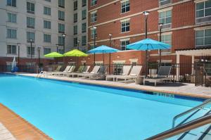 a swimming pool with lounge chairs and umbrellas at Hilton Garden Inn Atlanta Midtown in Atlanta