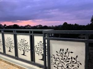a fence with trees painted on the side of it at The pine 2 bedroom house California plaza in Nanyuki