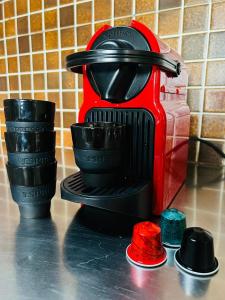 a red and black coffee maker on a counter at tHE Eagle Nest Duplex - Your Mountain Retreat in Chalais
