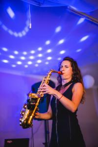 a woman playing a saxophone in a room at Hotel Rozkoš in Česká Skalice