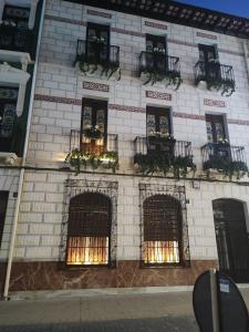 a white brick building with windows and fire escapes at Supl. 22 Cabernet in Novelda