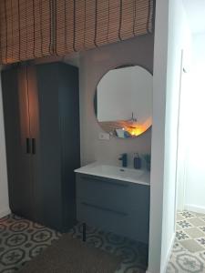 a bathroom with a sink and a mirror at Supl. 22 Cabernet in Novelda